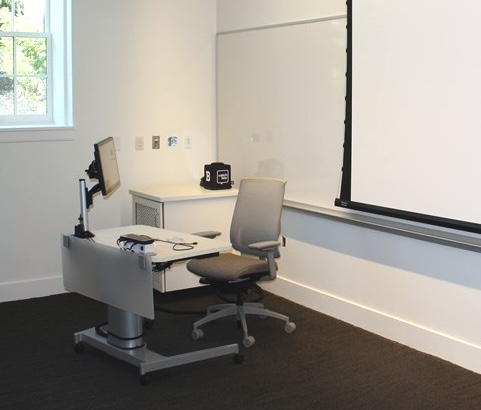 Instructor desk in the Sills Hall classroom with the touch screen and USBC cable for a laptop.