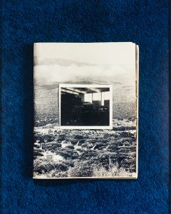 A photograph and landscape image from a print publication layered together on a royal blue carpet