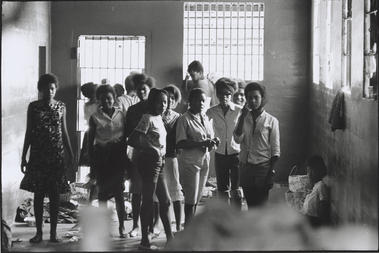 Photograph of about fifteen Black teenage girls standing around in a jail cell in Georgia