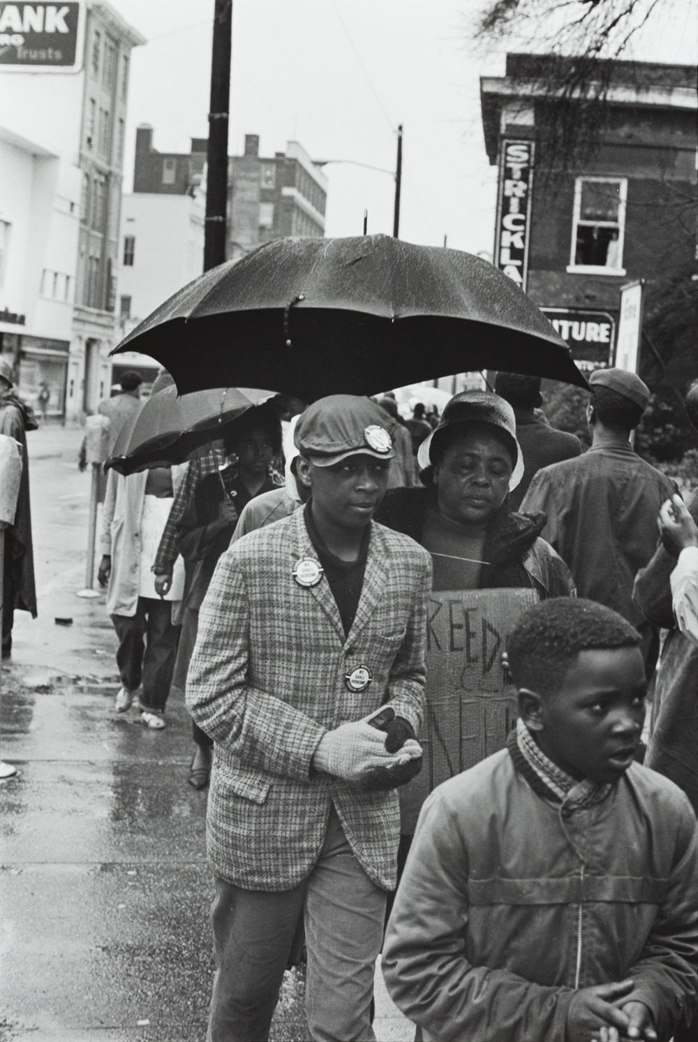 Photograph of Fannie Lou Hamer and other Black Mississippians demonstrating out in the rain